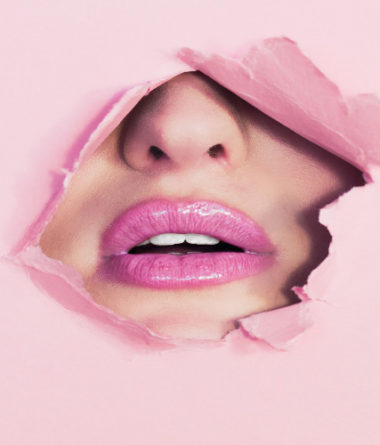 Lips behind pink paper - Ian Dooley